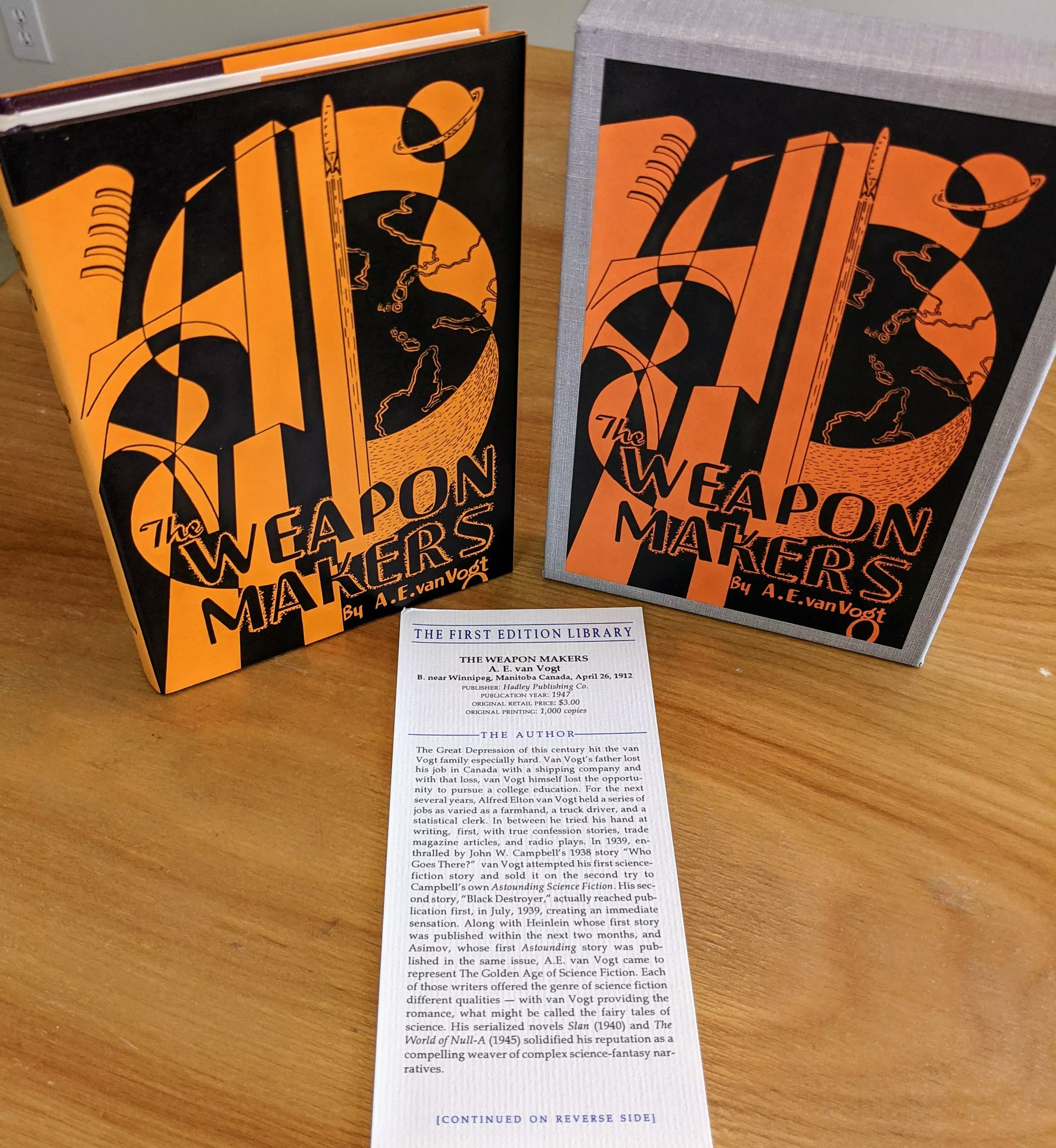 Pristine, unread copy of The Weapon Makers by A.E. van Vogt, by The First Edition Library, part of their  Facsimile First Editions series. The book, housed in its original fine grey slipcase, replicates the 1947 hardcover first edition with striking fidelity. The cover design features bold black and orange geometric art: a stylized Earth, Saturn-like planets, and towering futuristic weapons and structures, typical of mid-20th century science fiction aesthetics. The title, The Weapon Makers, and author credit appear in sharp, vintage-style fonts at the base of the design. The matching dust jacket reproduces the original's visual layout and color scheme exactly

This copy is from a single-owner private collection, stored unread in dust-free bookcases within a stable, dry climate. It is in as new condition, with the dust jacket and slipcase both immaculate. Also included is the original publisher's bookmark/note card, provided by the First Edition Library. The card details the book's original 1947 publication by Fantasy Press, noting its significance in van Vogt's Isher series. It includes a short essay on the author and his importance in Golden Age science fiction, the context of the novel's release, and bibliographic notes on the original edition

Published in the 1980s-1990s, these facsimiles are highly accurate, down to original typos, and double as reference works. This is an excellent collector-grade reproduction of a science fiction classic, preserved in flawless condition