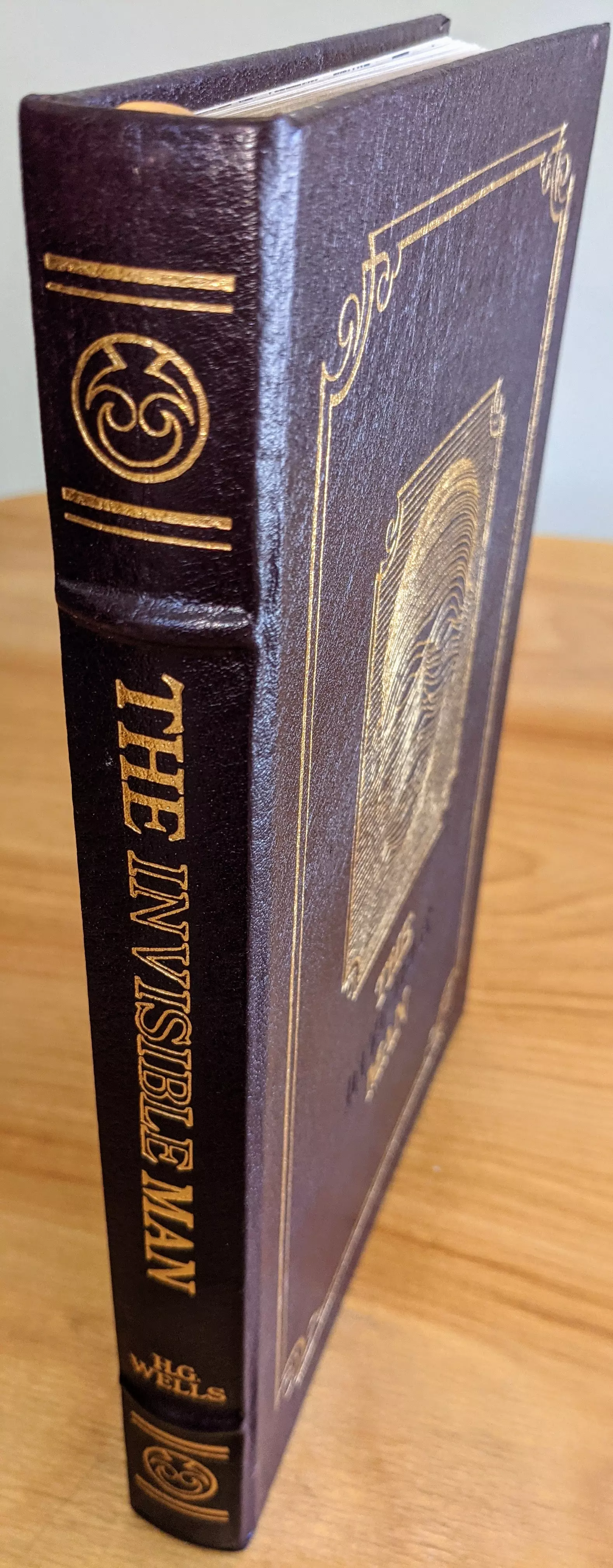 Stunning Dark Chocolate/Purple Leather Bound hardback book with hubbed spine, cover artwork in 22kt gold, printed on archival paper with gold gilded edges, smyth sewing & concealed muslin joints
	  - original artwork by Charles Mozley