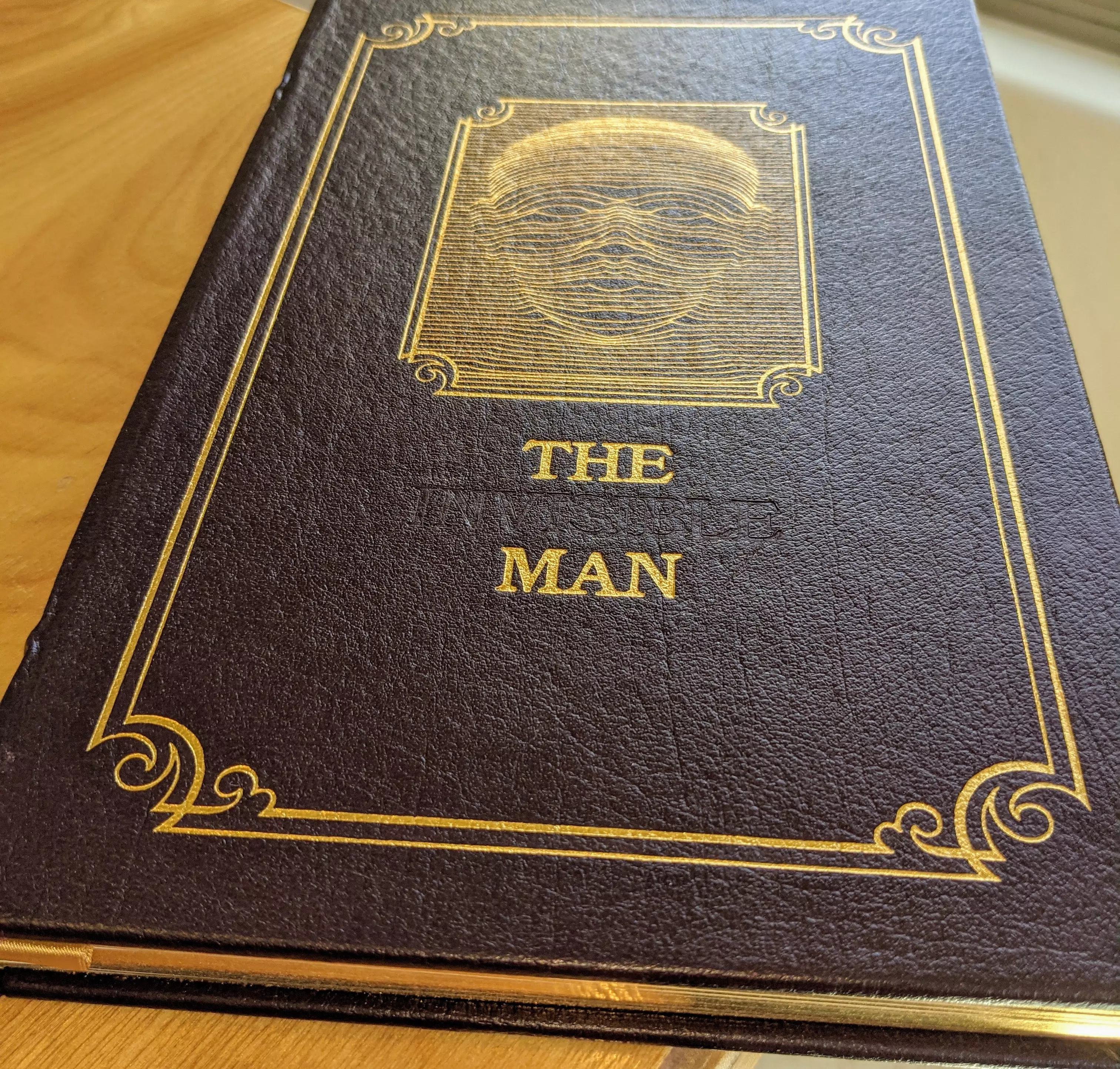 Stunning Dark Chocolate/Purple Leather Bound hardback book with hubbed spine, cover artwork in 22kt gold, printed on archival paper with gold gilded edges, smyth sewing & concealed muslin joints
	  - original artwork by Charles Mozley